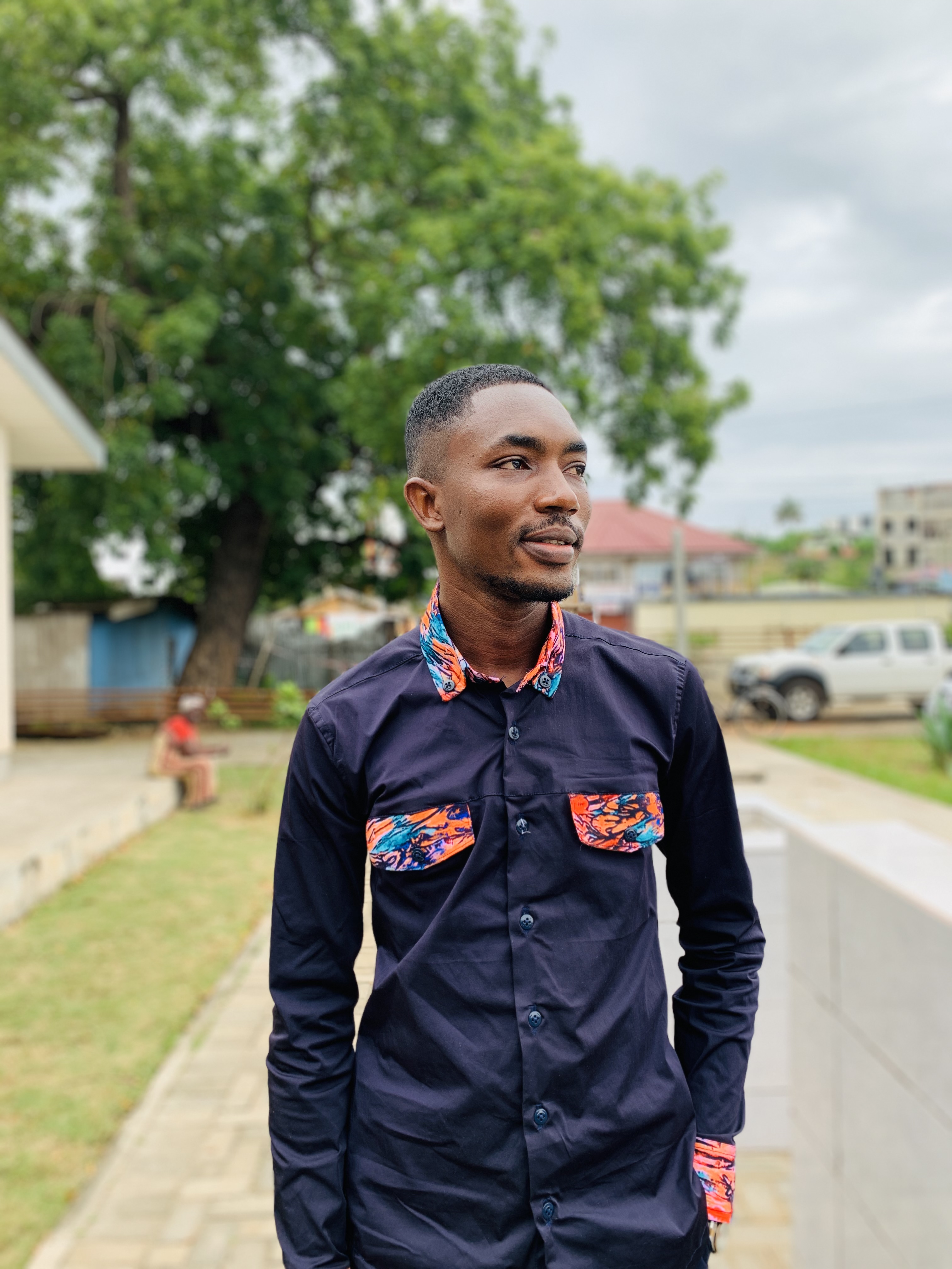 Navy shirt with colourful African print collar, pockets, and cuffs
